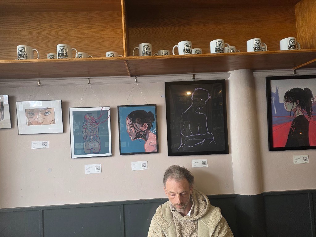A row of framed illustrations along the cafe wall